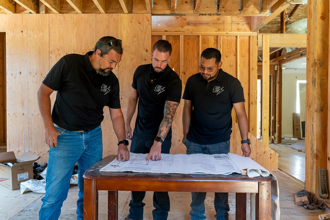 Executive Electric crew reviewing plans on a San Jose job site