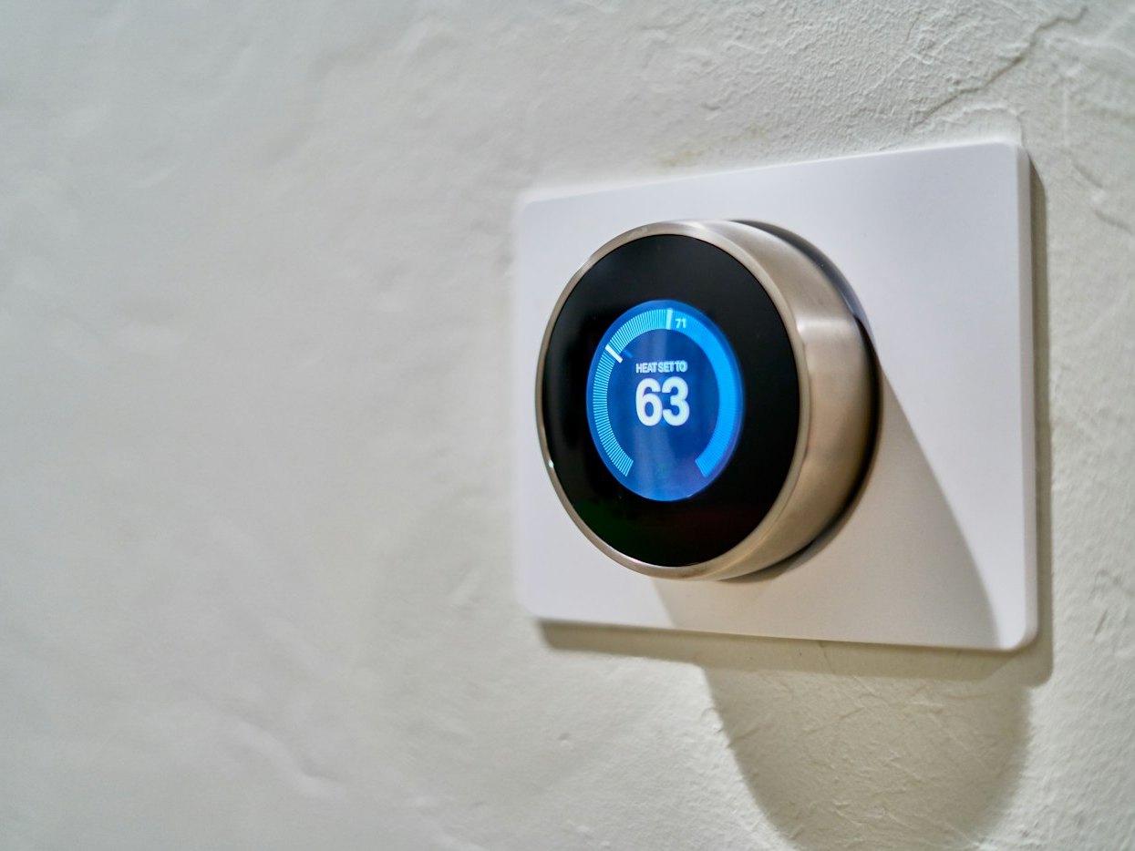 Smart thermostat installed on a home wall for home automation